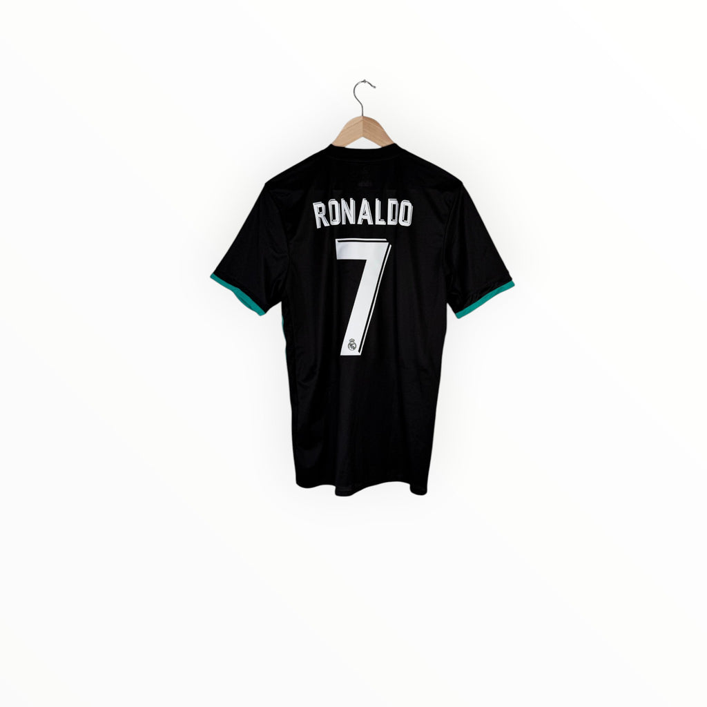 A black short-sleeve soccer jersey with 'RONALDO' and the number '7' printed in white on the back, hanging on a wooden hanger against a plain white background.
