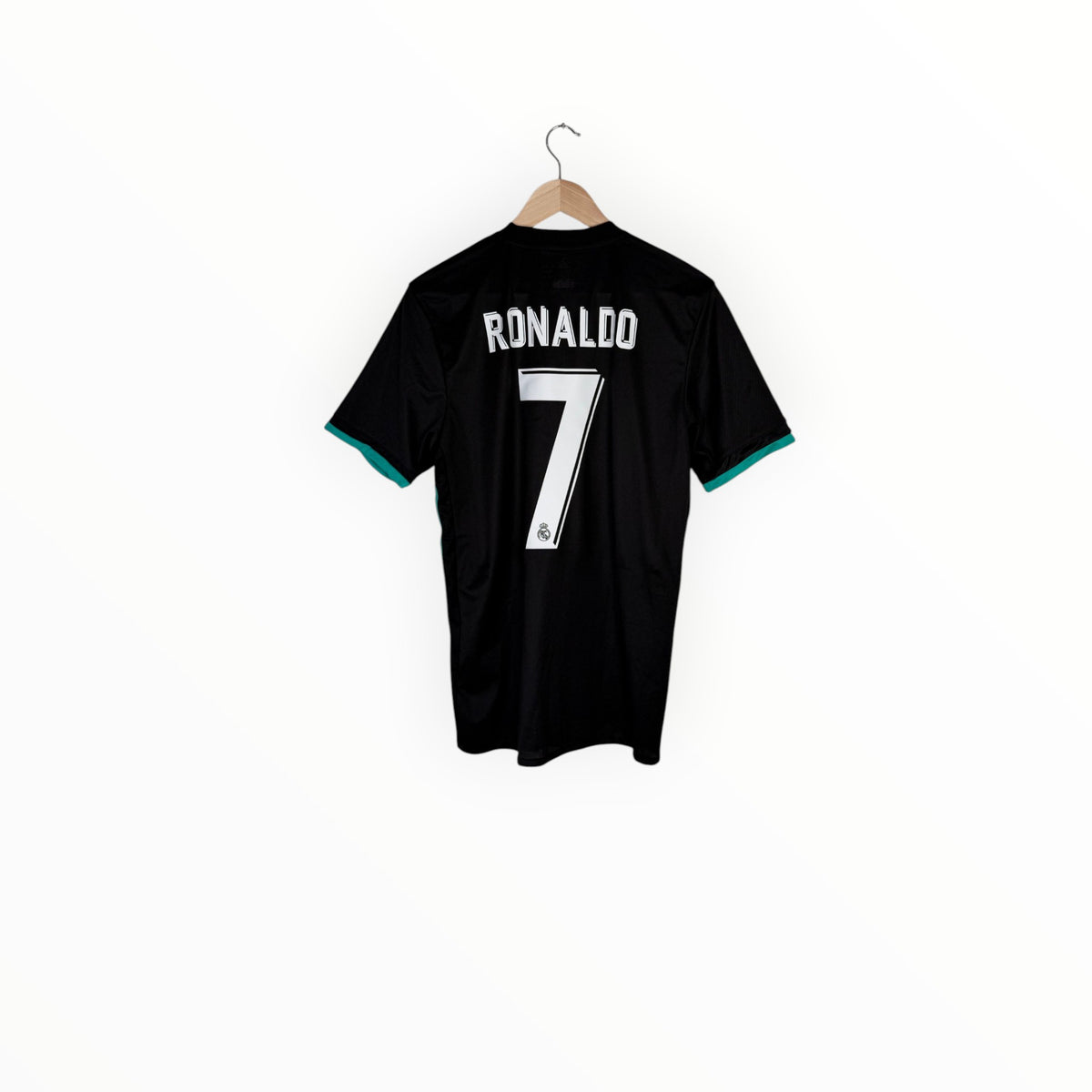 A black short-sleeve soccer jersey with 'RONALDO' and the number '7' printed in white on the back, hanging on a wooden hanger against a plain white background.