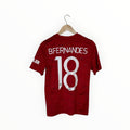A red short-sleeve soccer jersey hanging on a wooden hanger against a plain white background. The back of the shirt features the name 'BFERNANDES' and the number '18' in large white block letters.