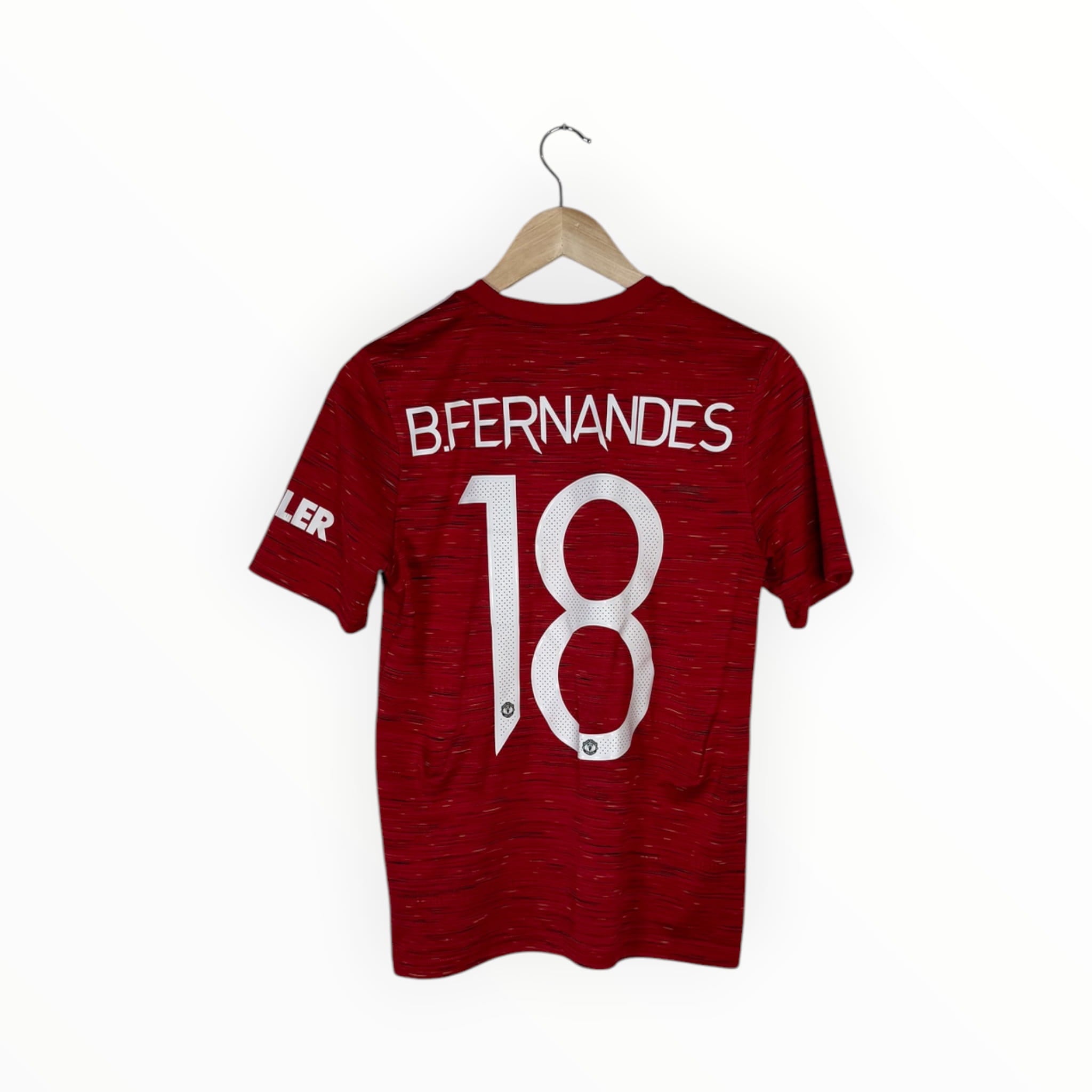 A red short-sleeve soccer jersey hanging on a wooden hanger against a plain white background. The back of the shirt features the name 'BFERNANDES' and the number '18' in large white block letters.