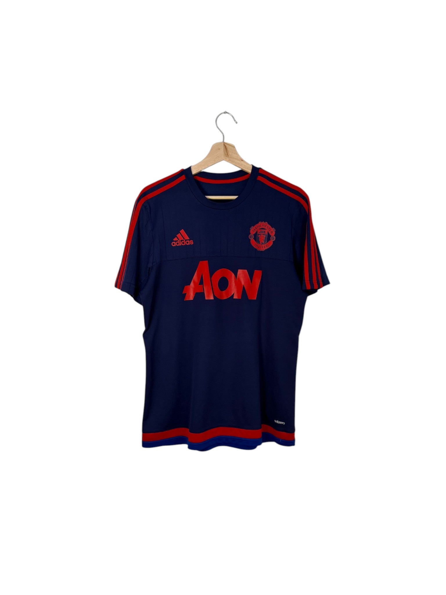 Manchester united navy jersey red logo
