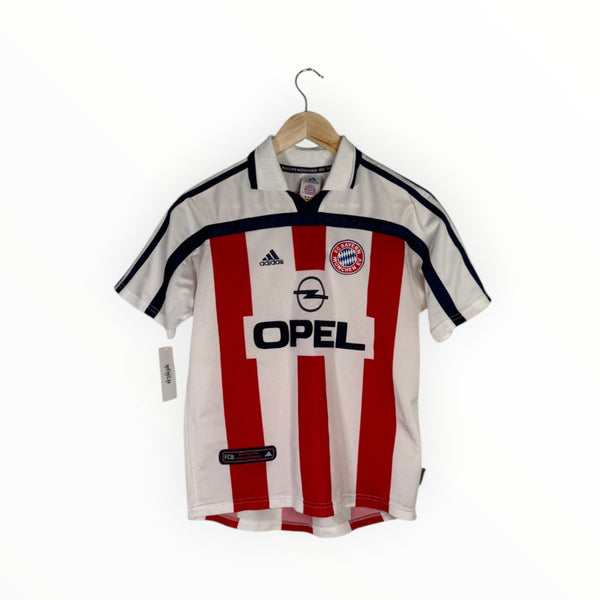 A vintage Adidas Bayern Munich home soccer jersey with red and white vertical stripes, featuring the Opel sponsor logo and Adidas logo, hanging on a wooden hanger against a white background.