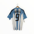 A light blue and white striped Argentina soccer jersey with 'BATISTUTA' and the number '9' on the back, hanging on a wooden hanger against a white background.