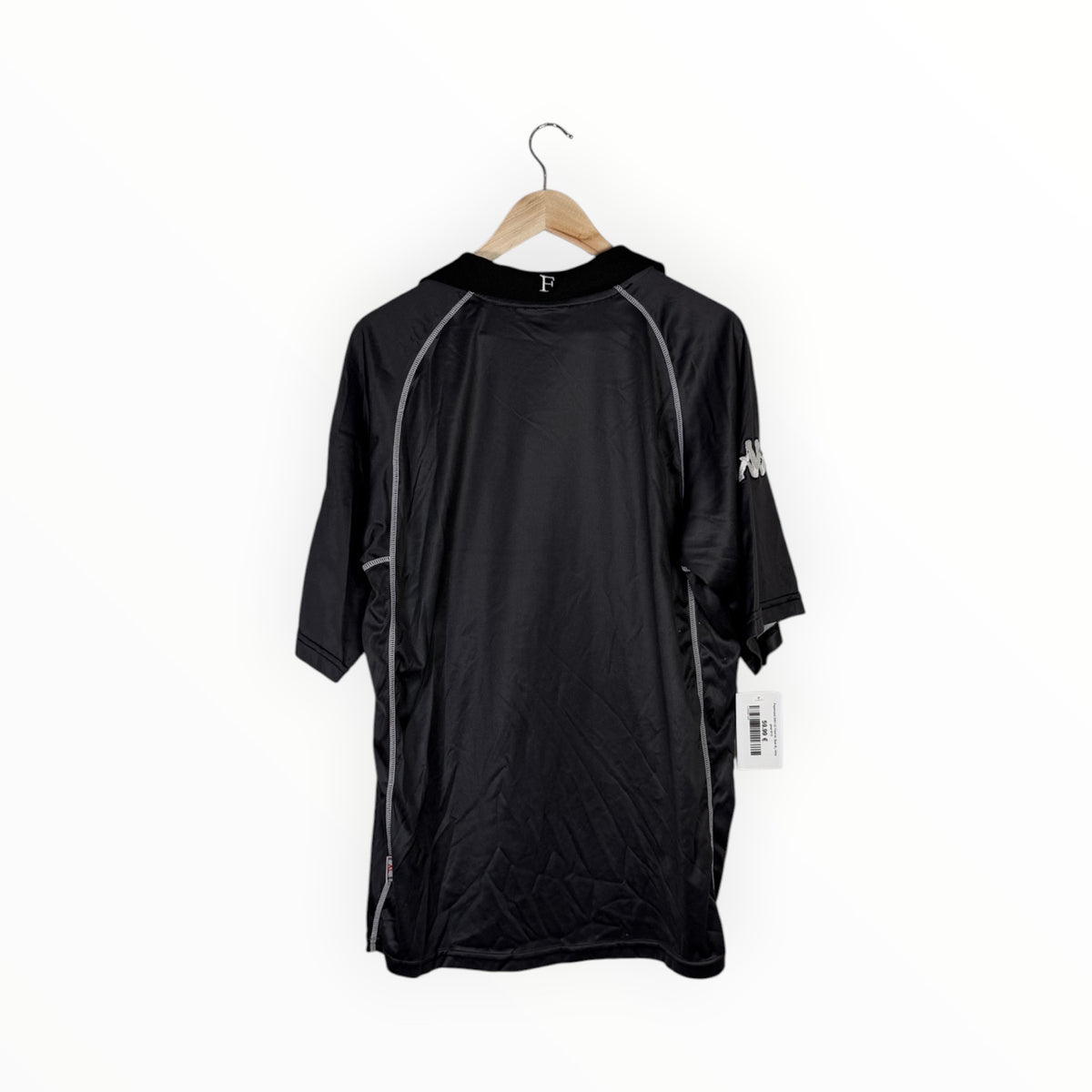 A black hooded athletic jacket with gray piping details and a white logo on the sleeve, hanging on a wooden hanger against a plain white background.