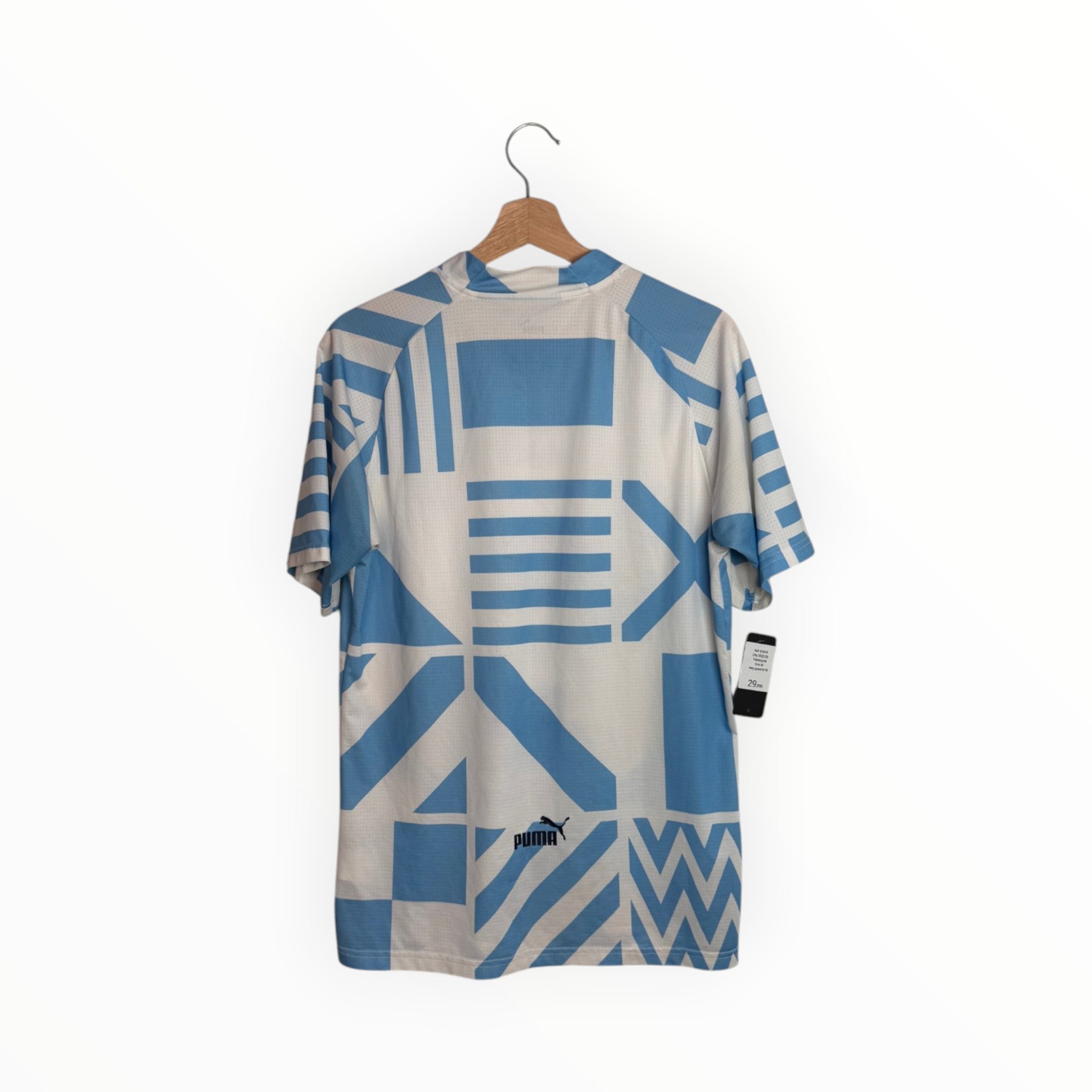 blue and white manchester city football shirt