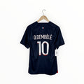A navy blue soccer jersey with 'O. DEMBÉLÉ' and the number '10' printed on the back, hanging on a wooden hanger against a plain white background.