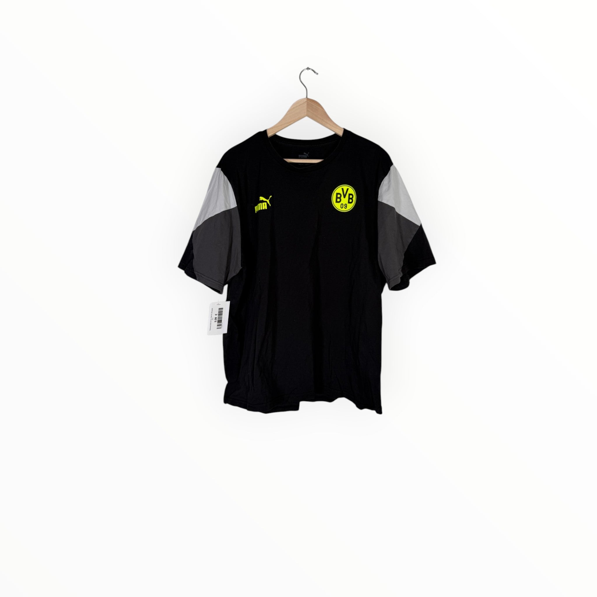 A black Borussia Dortmund short-sleeve t-shirt with gray color-blocked sleeves, hanging on a wooden hanger against a plain white background.