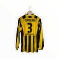 A vintage yellow and black striped long-sleeve soccer jersey with 'EVANILSON' and the number '3' on the back, hanging on a wooden hanger against a white background.