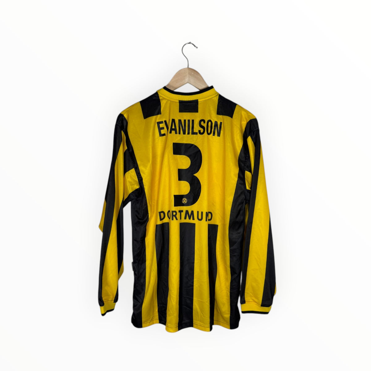 A vintage yellow and black striped long-sleeve soccer jersey with 'EVANILSON' and the number '3' on the back, hanging on a wooden hanger against a white background.