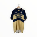 A vintage Kappa Stadium Rotterdam Vizkringen soccer jersey in navy blue and beige, hanging on a wooden hanger against a plain white background.