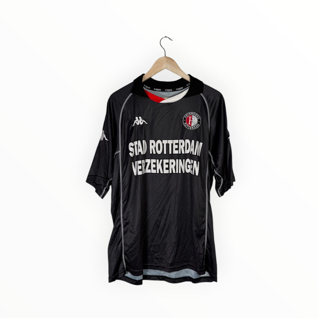 A vintage black Kappa soccer jersey for SC Rotterdam, hanging on a wooden hanger against a plain white background. The jersey features white text reading 'STAD ROTTERDAM VEZEKERING' across the chest, with the Kappa logo on the right chest and the SC Rotterdam crest on the left.