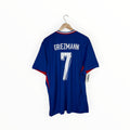 A royal blue soccer jersey with 'GREZMANN' and the number '7' printed in white on the back, hanging on a wooden hanger against a plain white background.