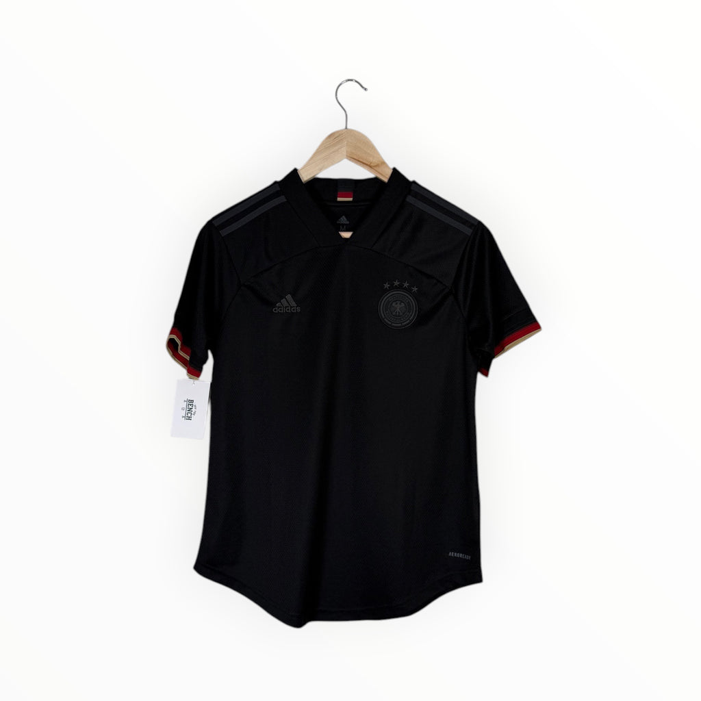 A black Adidas Germany soccer jersey hanging on a wooden hanger against a plain white background. The jersey features the German national team crest on the left chest, the Adidas logo on the right chest, and subtle red and gold trim on the sleeve cuffs.