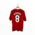 A red short-sleeve soccer jersey hanging on a wooden hanger against a plain white background. The back of the shirt features the name 'GERRARD' in white arched lettering above a large white number '8'.
