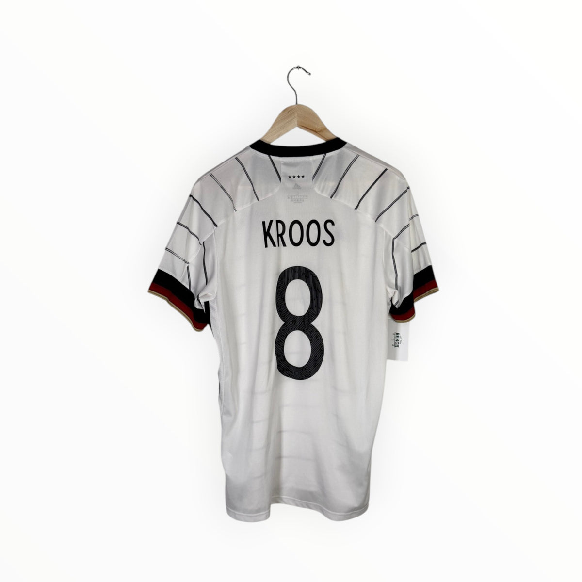 A white Germany national team soccer jersey with 'KROOS' and the number '8' printed on the back, hanging on a wooden hanger against a white background.