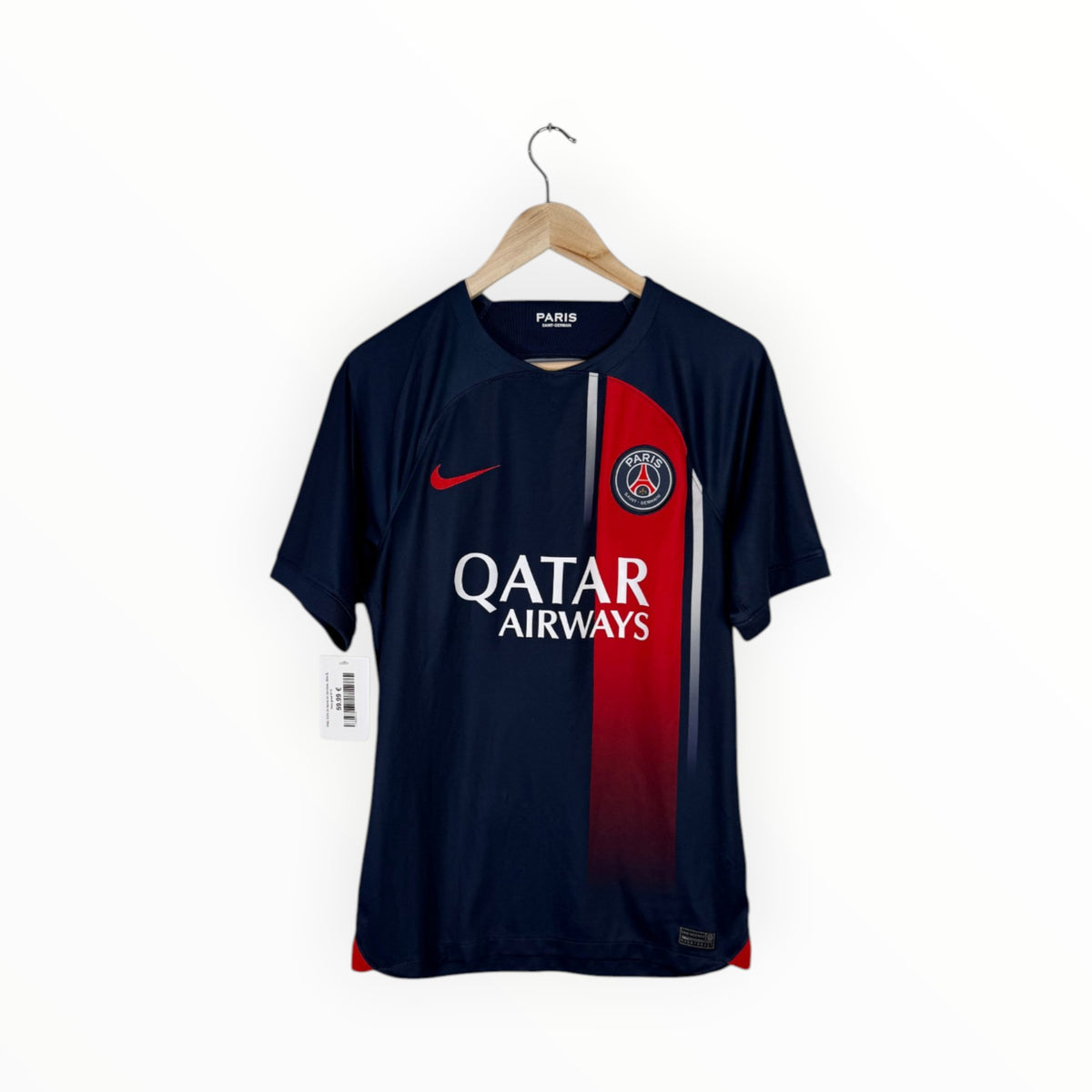 A Paris Saint-Germain Nike soccer jersey in navy blue, featuring a vertical red gradient stripe down the right side, the club crest on the chest, and 'QATAR AIRWAYS' sponsor text across the front. The jersey is displayed on a wooden hanger against a plain white background.