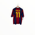 A Barcelona FC Rivaldo number 11 soccer jersey hanging on a wooden hanger against a plain white background.