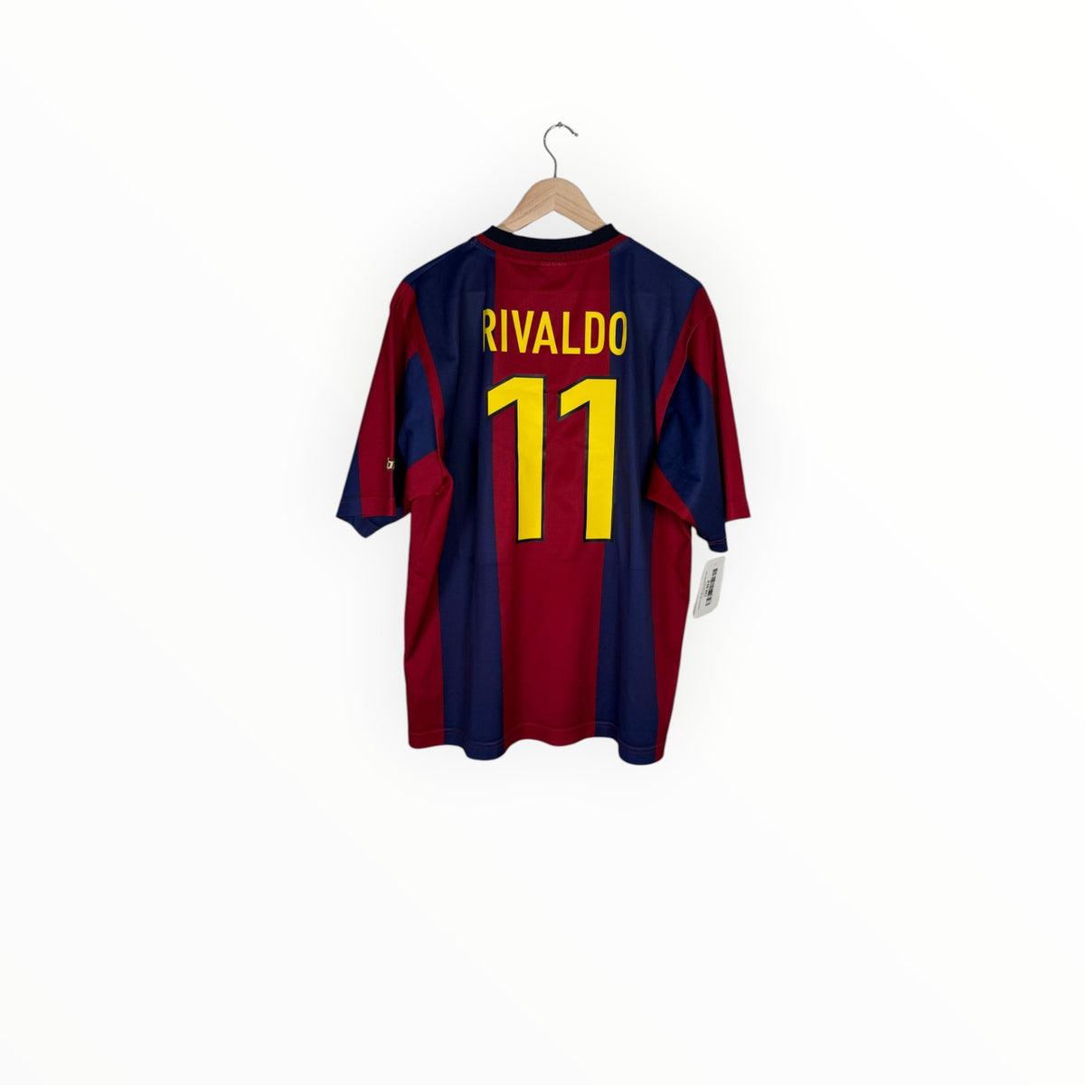 A Barcelona FC Rivaldo number 11 soccer jersey hanging on a wooden hanger against a plain white background.