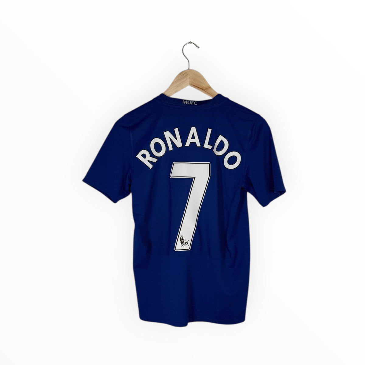 A navy blue short-sleeve soccer jersey with 'RONALDO' and the number '7' printed in white on the back, hanging on a wooden hanger against a plain white background.