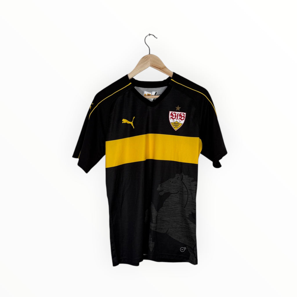 A black and yellow Puma soccer jersey with a horse graphic, hanging on a wooden hanger against a white background.