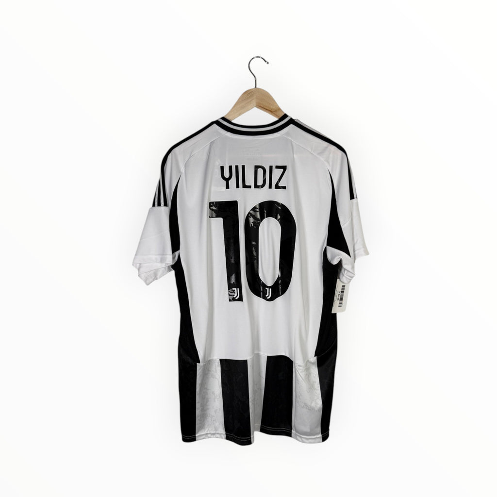 A white and black striped Juventus soccer jersey with 'YILDIZ 10' printed on the back, hanging on a wooden hanger against a white background.